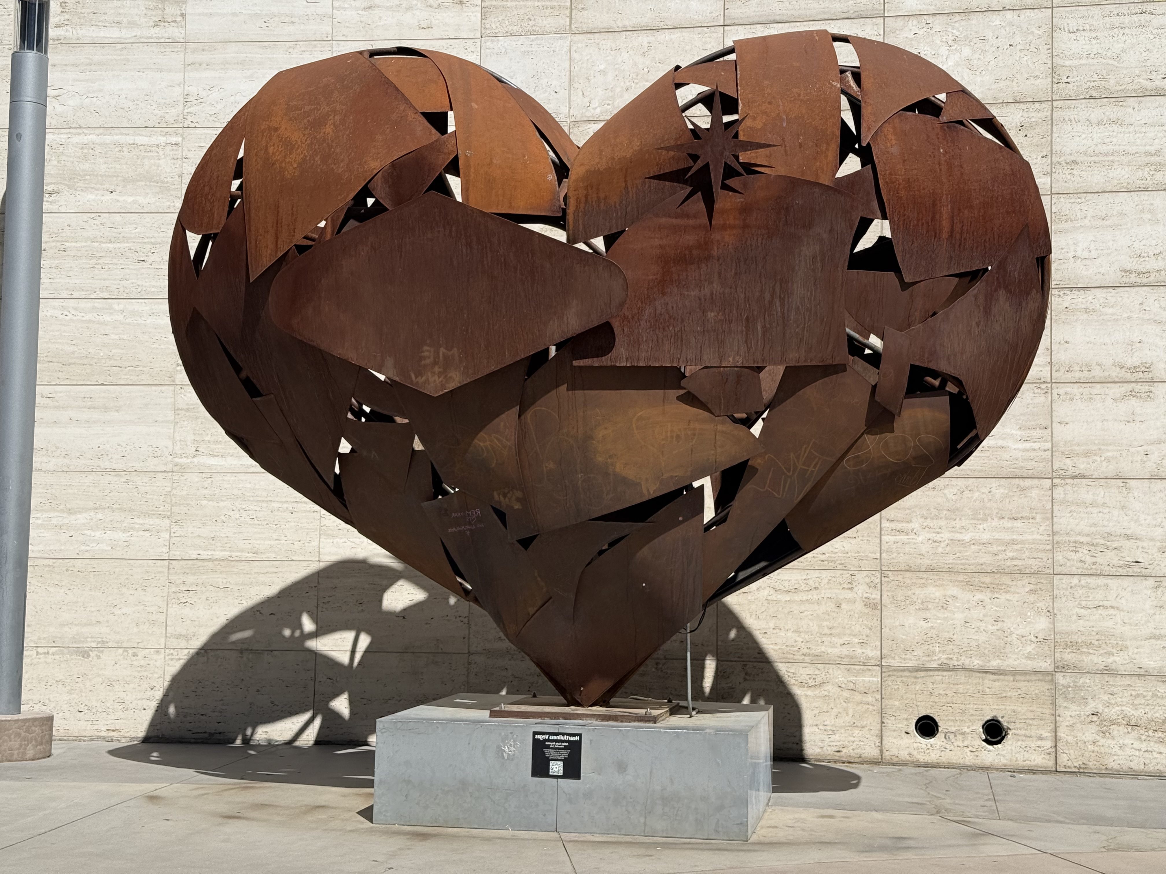 Heartfullness by Katy Boynton, a large rust-colored metal heart with openings that let light through, outside Fashion Show Mall in Las Vegas.